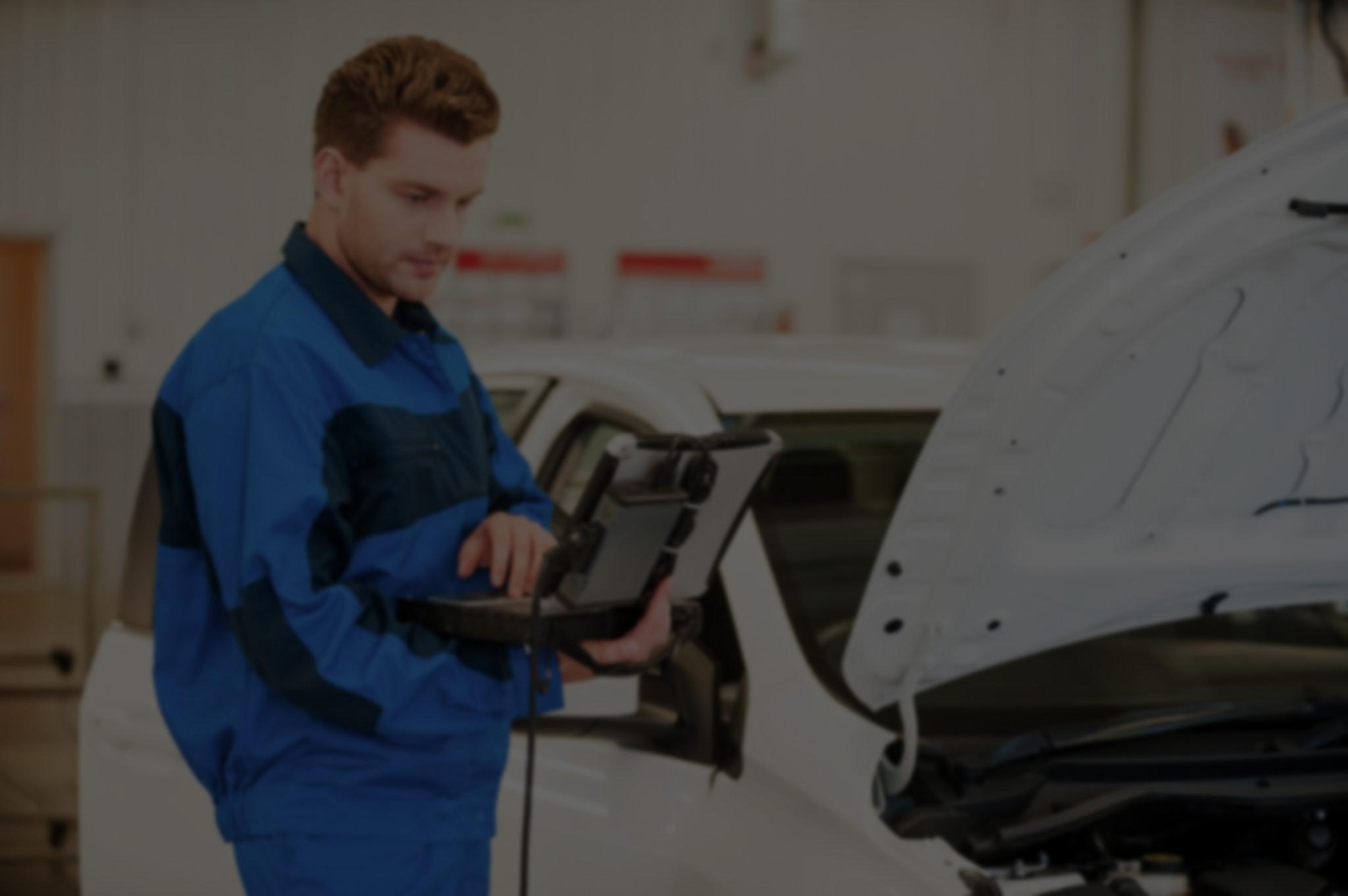 mechanic-examining-car-blurred-overlay-mirrored-dark